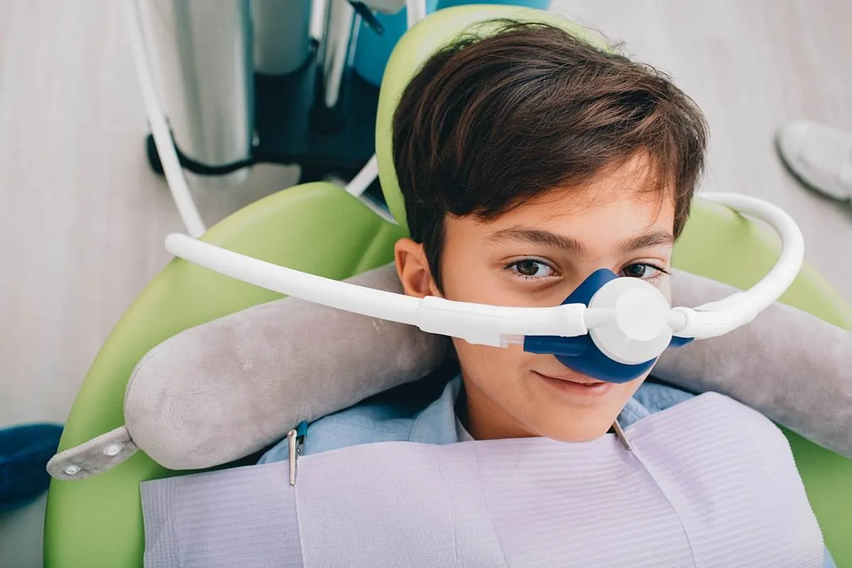 Little boy getting Inhalation Sedation while teeth treatment at dental clinic. Teeth treatment child Little boy getting Inhalation Sedation while teeth treatment at dental clinic. Teeth treatment child
