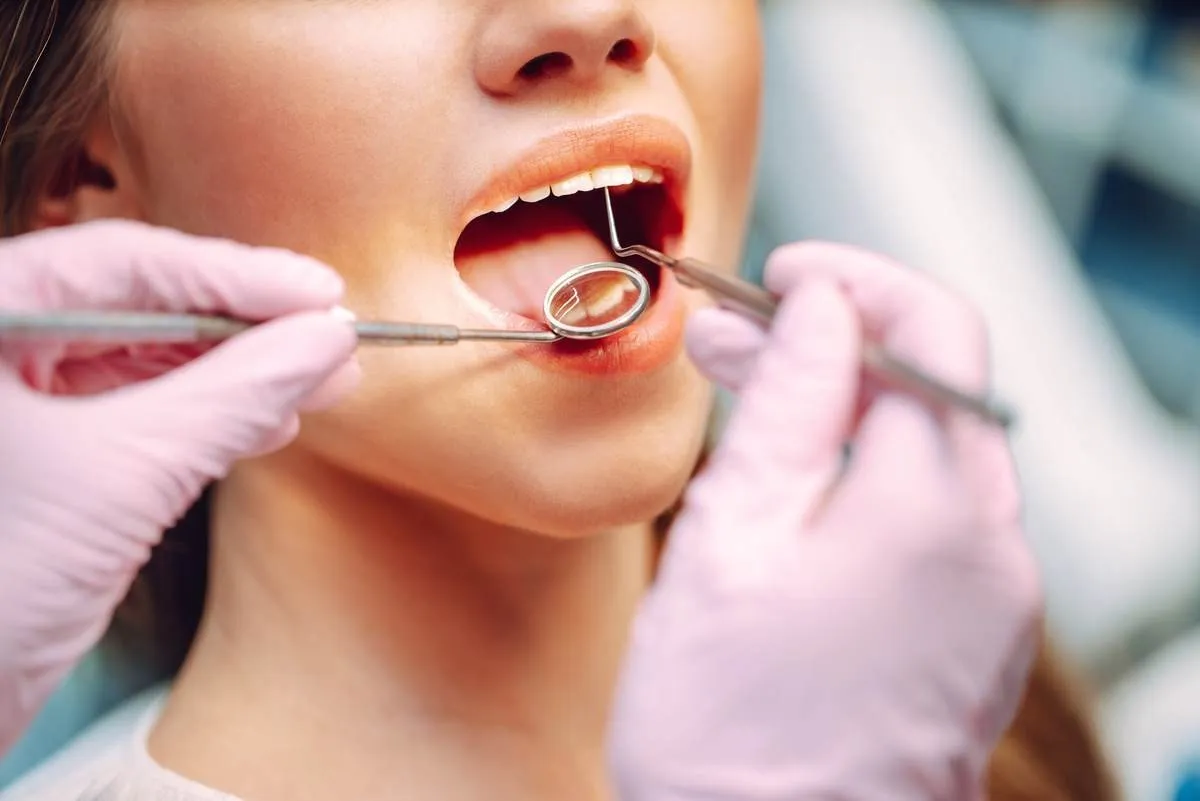 Overview of dental caries prevention. Dentist examining patient’s teeth in modern clinic. Healthy teeth and medicine concept. Overview of dental caries prevention. Dentist examining patient's teeth in modern clinic. Healthy teeth and medicine concept.