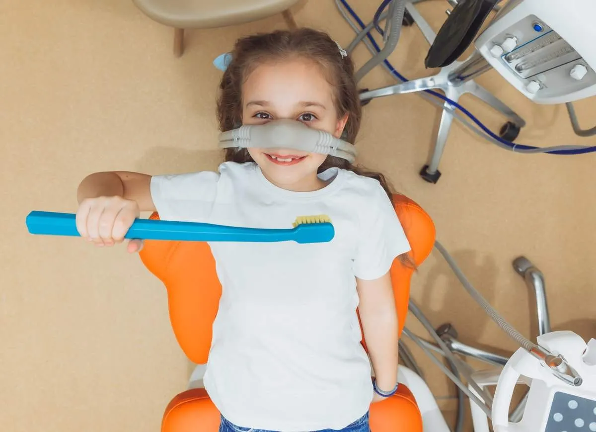 little girl with sedation mask.Treatment of children's teeth with nitrous oxide.children's dentistry.