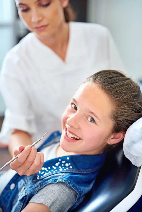 Girl, child and portrait at dentist for healthcare with dental tool, consultation or mouth inspection for oral health. Orthodontics, kid patient or hand for teeth cleaning, gingivitis or medical care Girl, child and portrait at dentist for healthcare with dental tool, consultation or mouth inspection for oral health. Orthodontics, kid patient or hand for teeth cleaning, gingivitis or medical care.