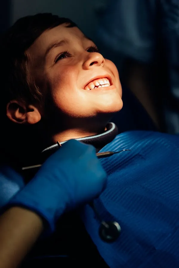 Dentists with a patient during a dental intervention to boy. Dentists with a patient during a dental intervention to boy. Dentist Concept