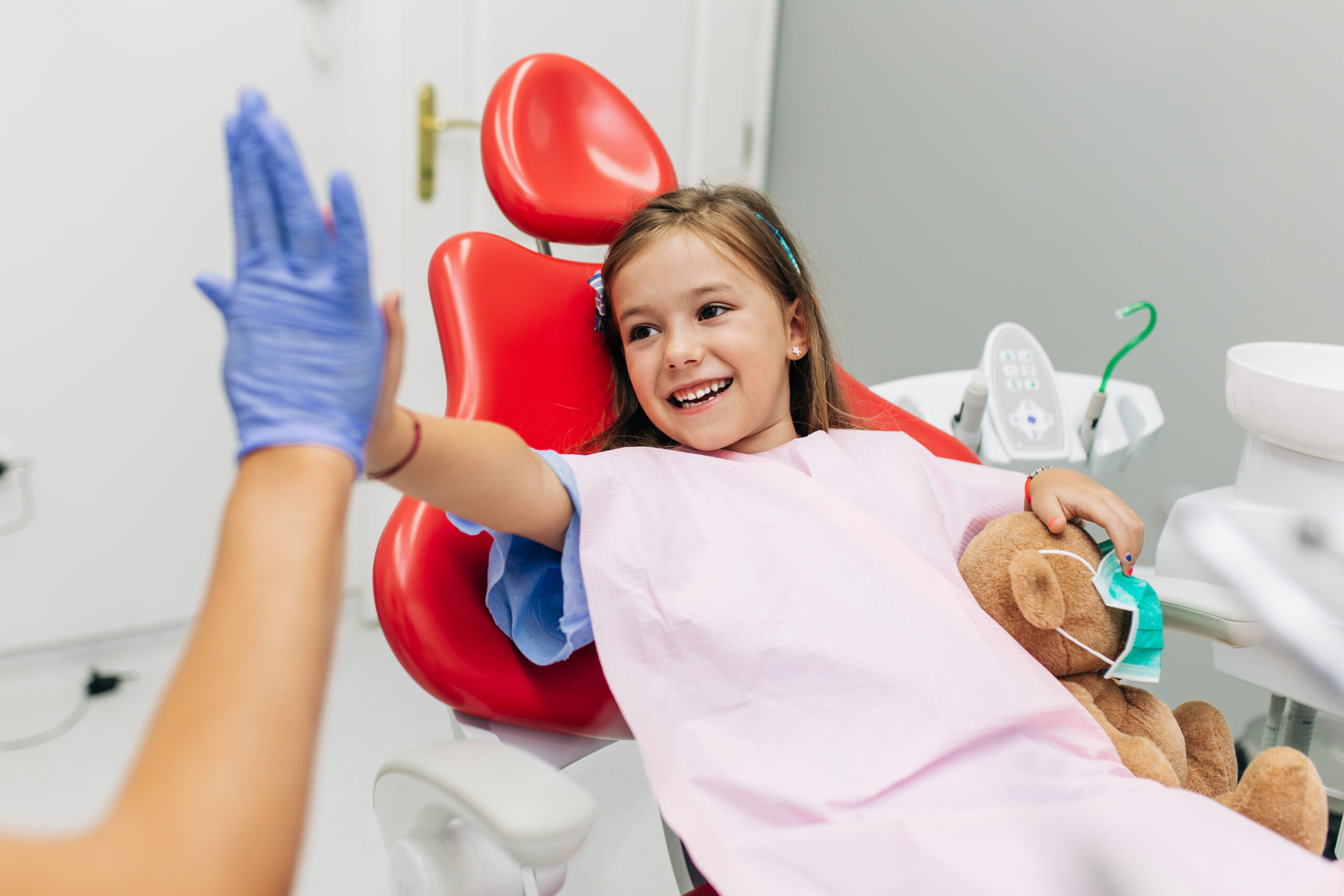 Cute little girl sitting on dental chair and having dental treat Cute little girl sitting on dental chair and having dental treatment.