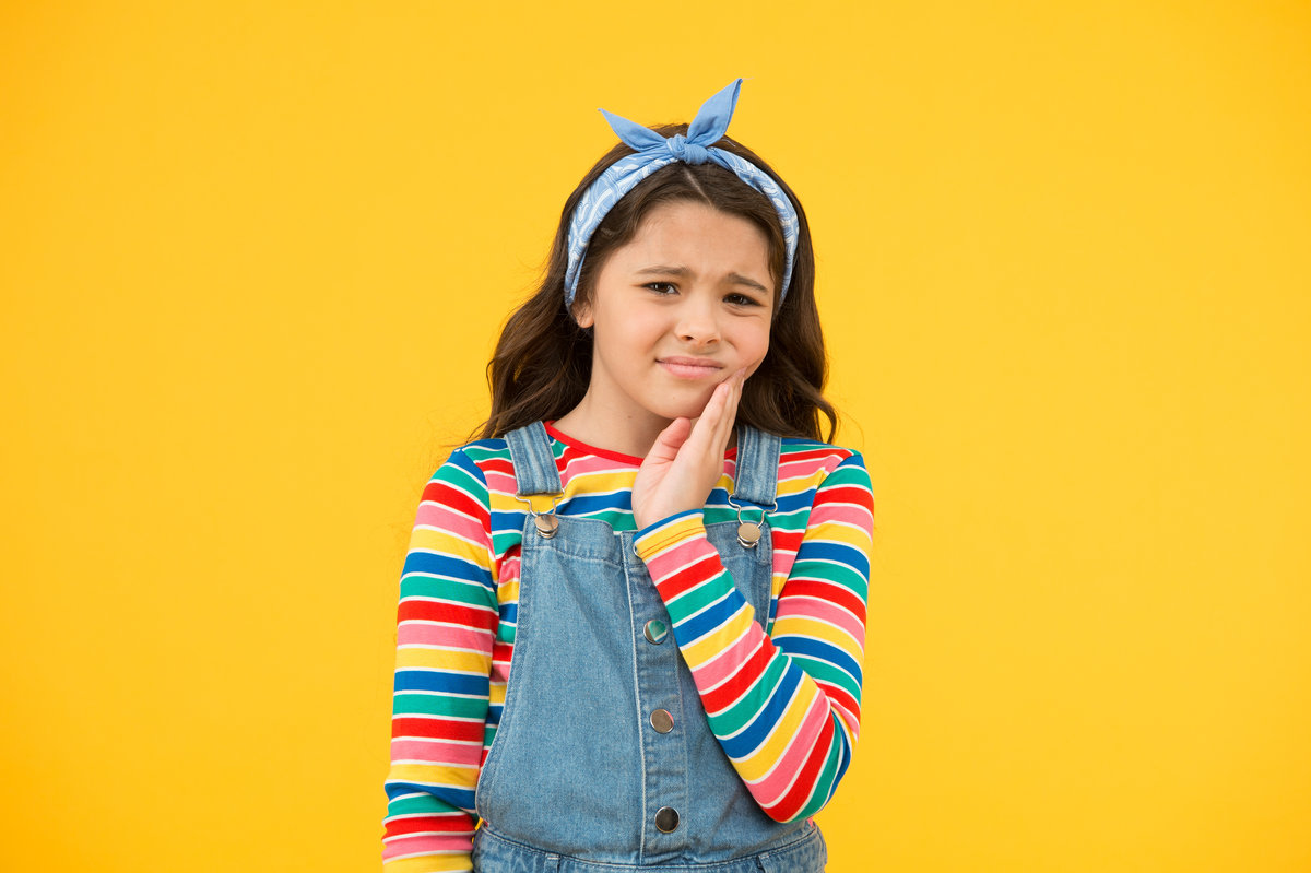 Dental disease. Toothache as dental pain. Plan to visit dentist. Dentist appointment. Little child suffer from toothache yellow background. Anti toothache remedy. Toothache painkiller. Pain relief.