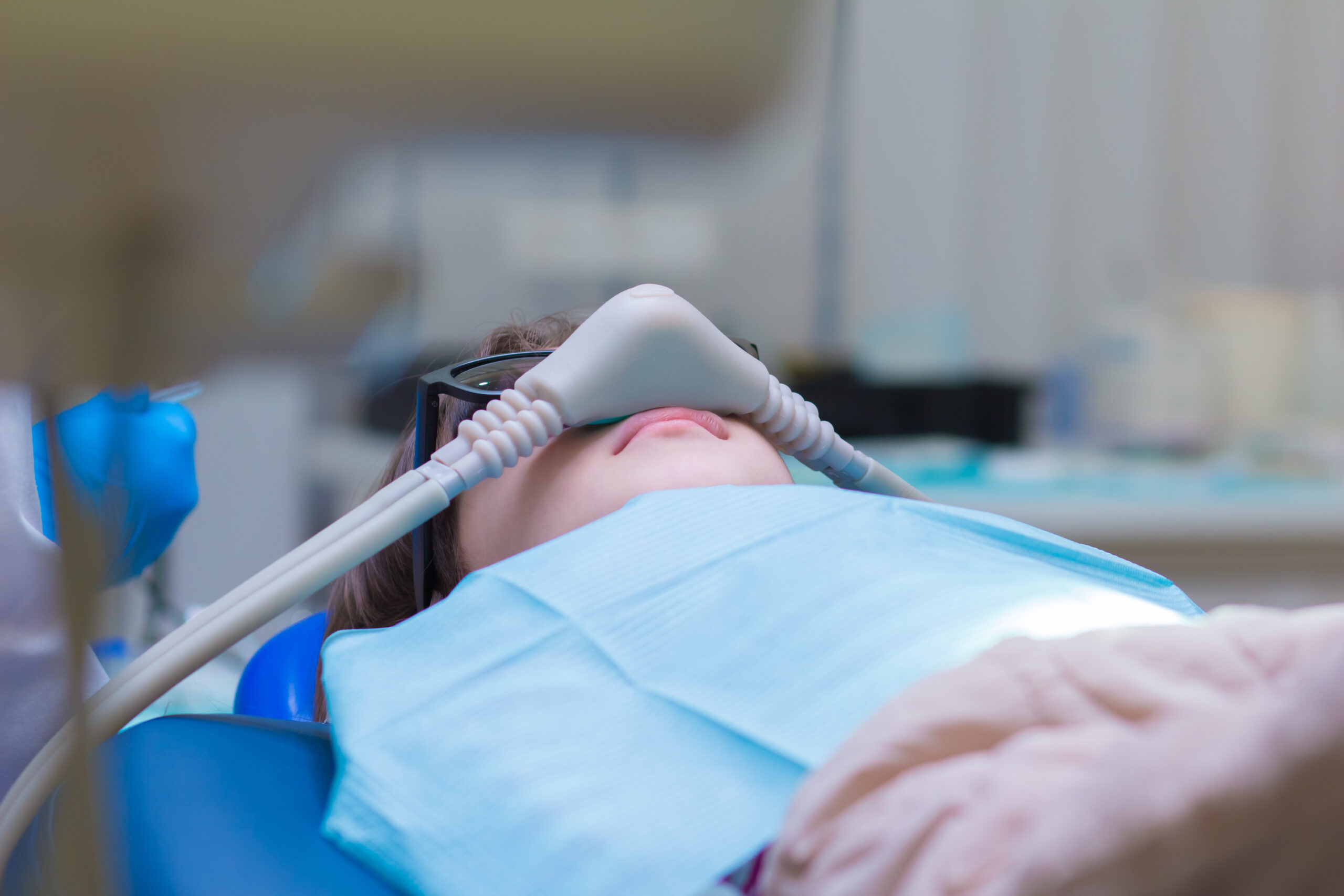 Dentistry. Dental treatment for children in the clinic under sedation. Dentistry. Little girl getting Inhalation Sedation while teeth treatment at dental clinic. Teeth treatment child.