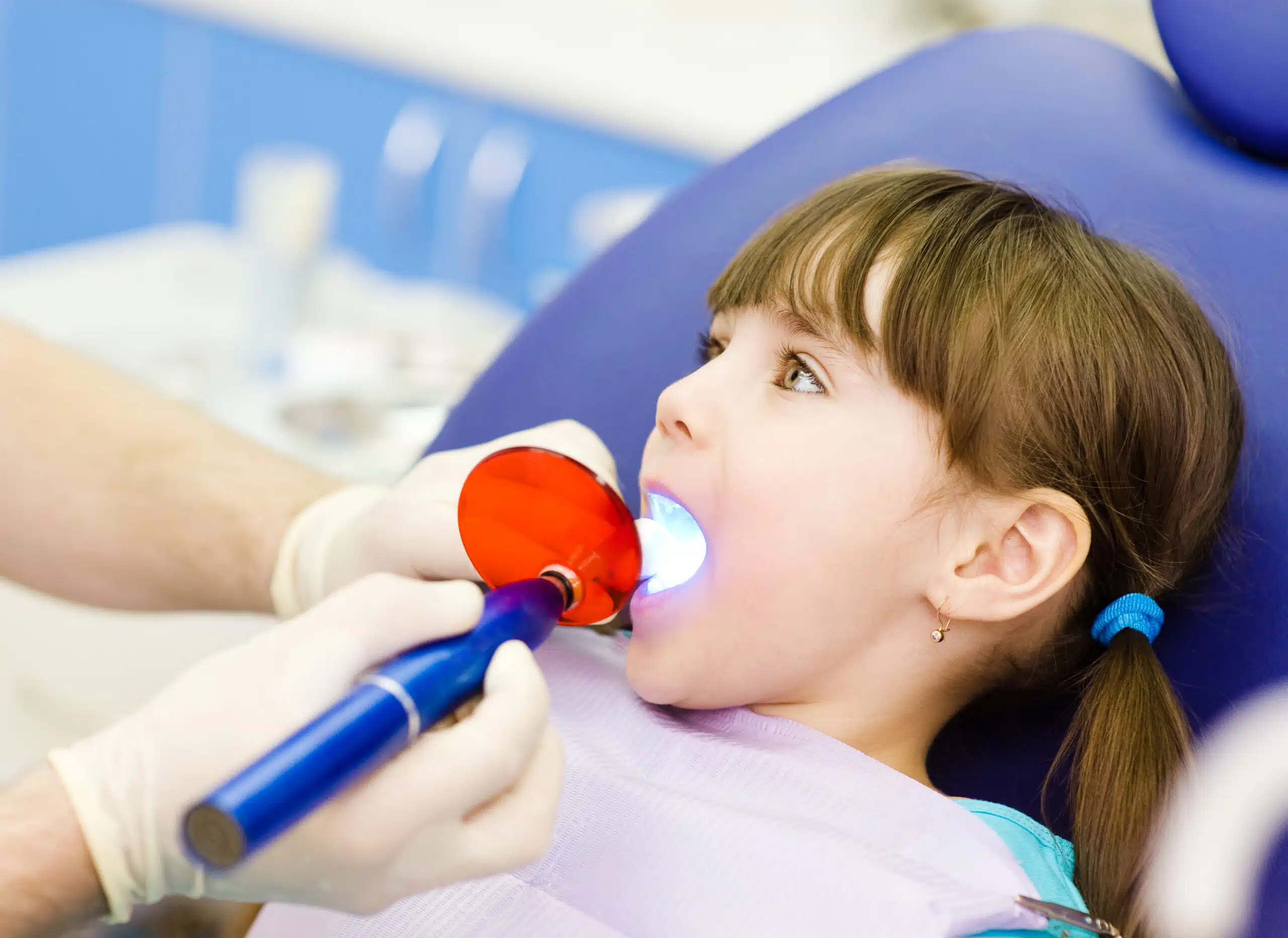 little girl with open mouth receiving dental filling drying proc little girl with open mouth receiving dental filling drying proc